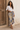 Flourish Bronze Silk Scarf, 135 × 135 cm, worn as a sarong in Lamu
