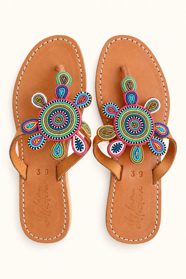 Corona leather sandals with multicolored circular beadwork and teardrop motifs, pair viewed from above.
