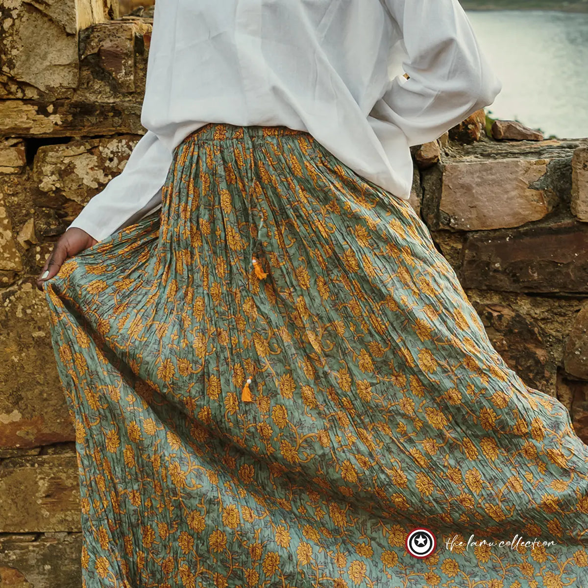 Green patterned skirt worn with a white shirt.