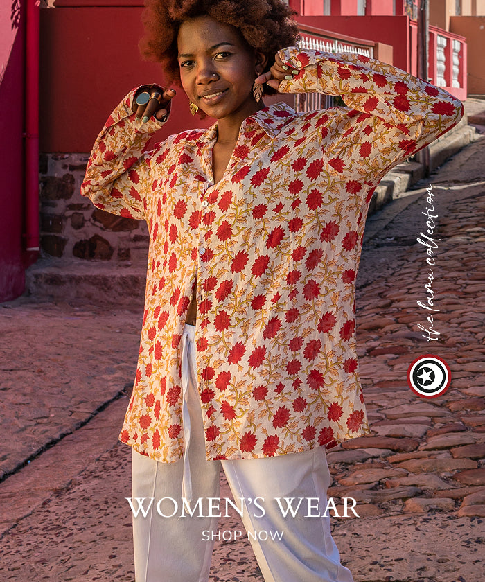 Woman wearing a red and yellow printed shirt.