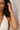 Close-up of the sculpted Mitende leaf brass bangle on a raised wrist.