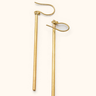 Fimbo brass earrings on a light background.