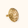 Dhana brass ring on a light background.