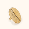 Nusu Mwezi Hammered brass ring on a light background.