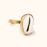 Shela brass ring on a light background.