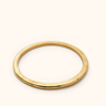 Mduara Smooth brass bangle on a light background.