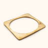 Ndani Hammered brass bangle on a light background.