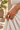 Pembe Black and White brass ring worn on a hand gently gathering ivory linen in a Lamu courtyard.