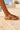 Champali Rainbow Circles beaded leather sandal worn on a pale plaster landing.