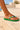Champali Thick Sole Green sandal worn on a pale plaster step, showing the thick green sole